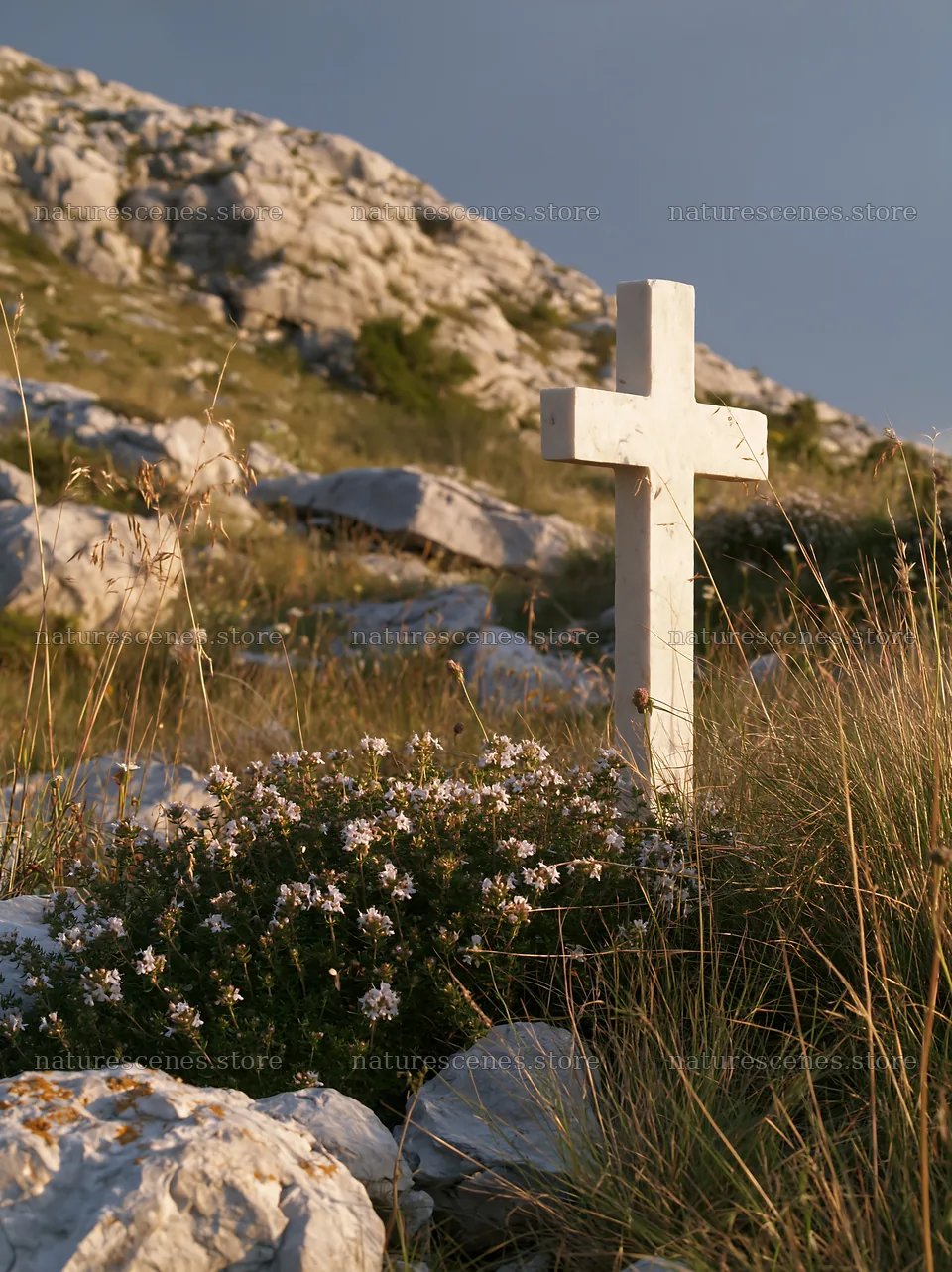 White Christian cross in a remote meadow surrounded by rocks – nature scenes 6866x9174