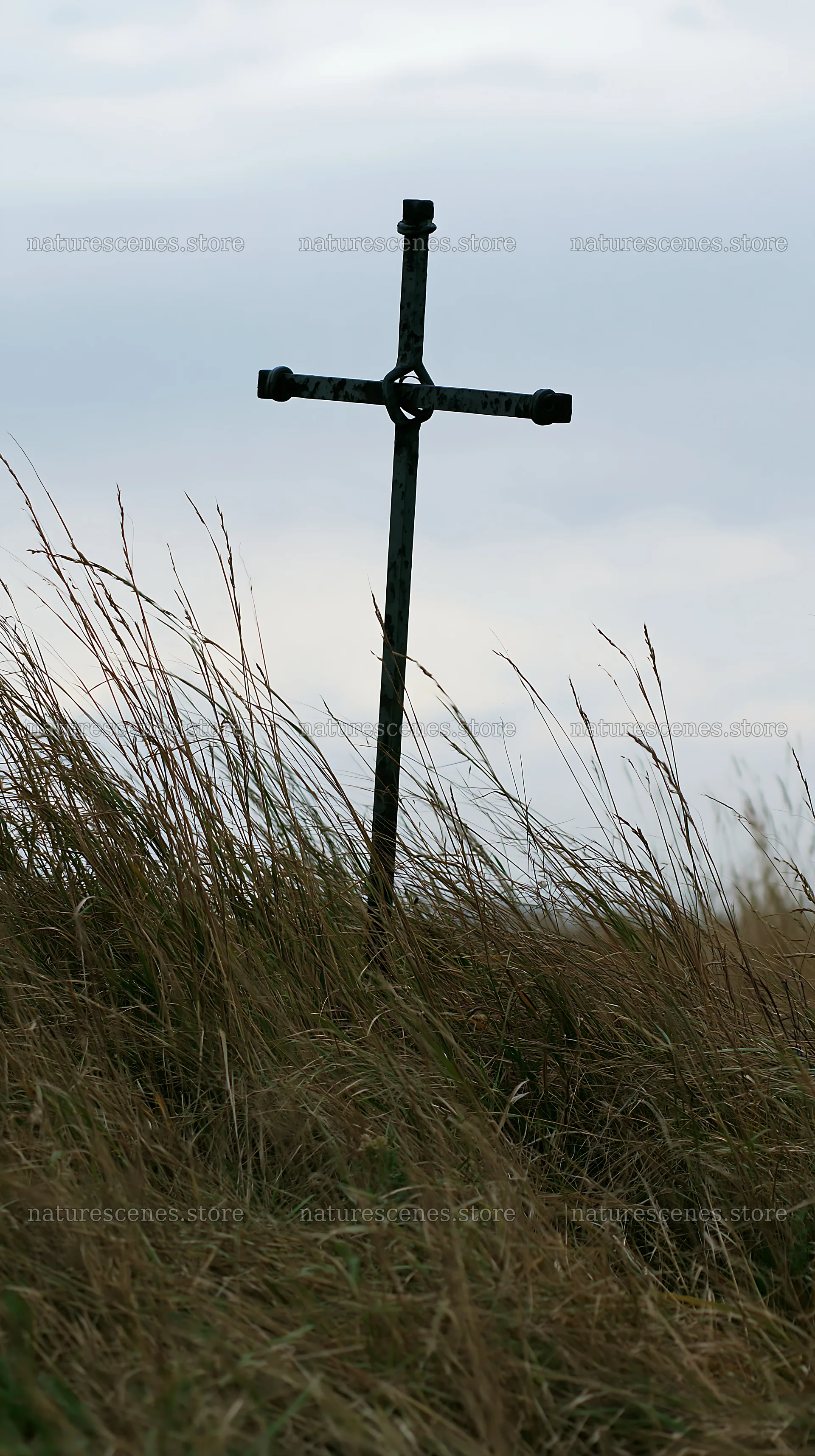 Iron Christian cross in meadow overlooking valley landscape – nature scenes 5938x10608