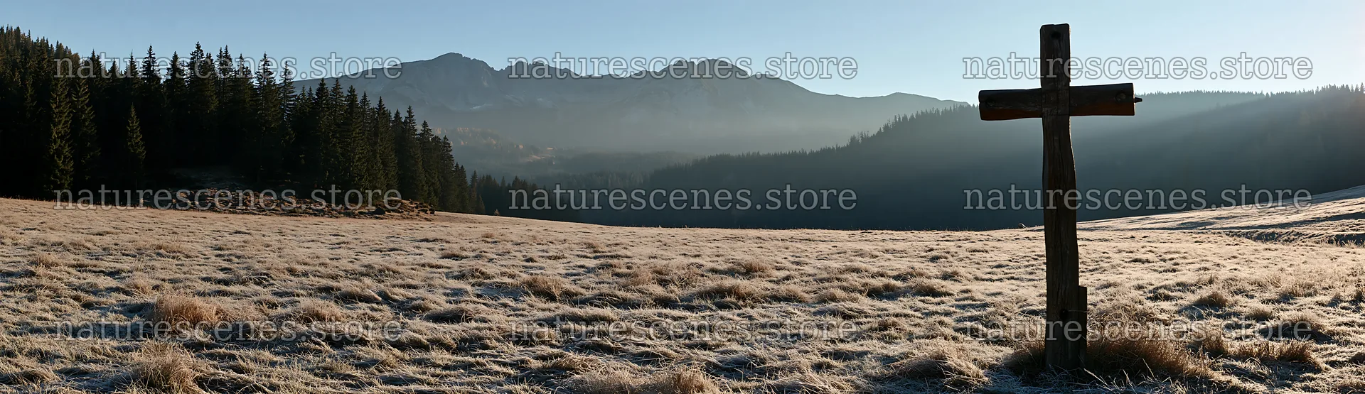 Carved oak cross in frosted meadow with mountains in background – nature scenes 14762x4268