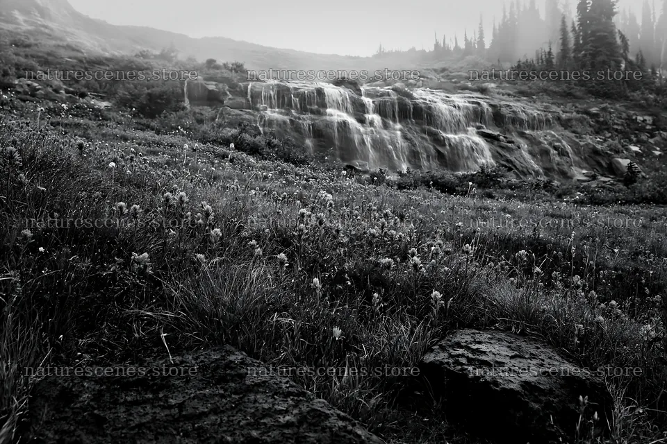 Misty mountain waterfall in a meadow with rocks and grass – nature scenes 9722x6480