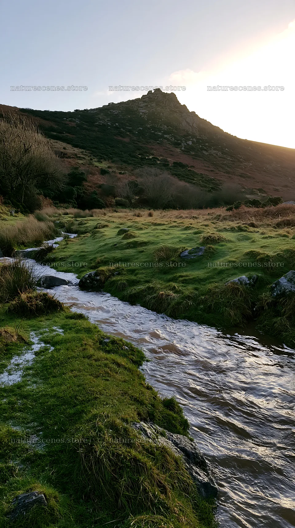 Meadow with stream beneath crags at sunset in a natural setting – nature scenes 5938x10608