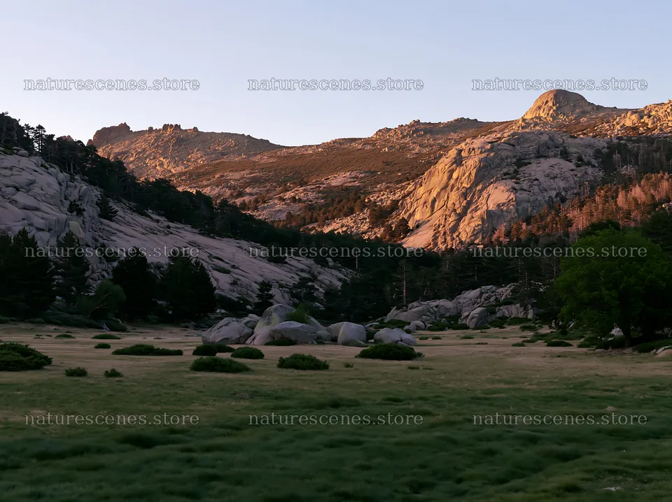 Meadow beneath rocky crags at sunset – nature scenes 9174x6866